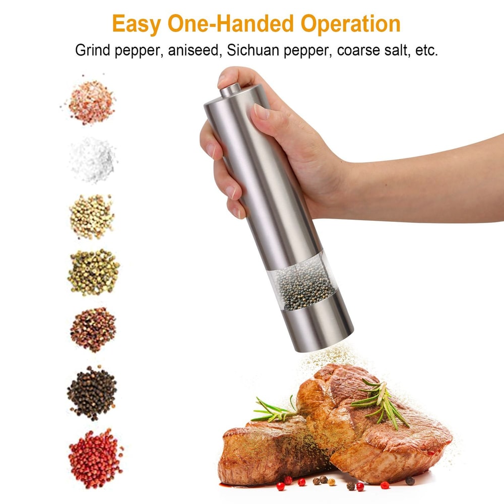 Person using stainless steel electric pepper grinder, seasoning steak with various spices.
