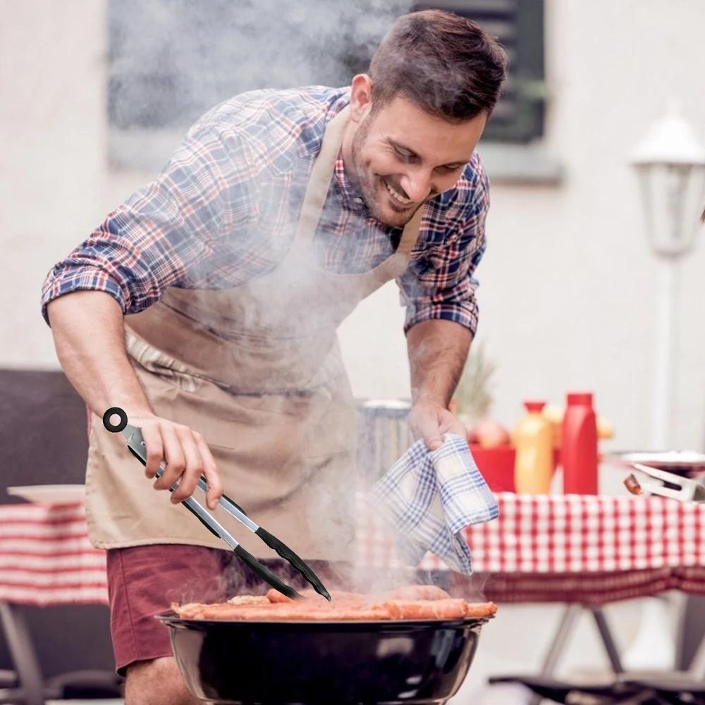 Man grilling meat with barbecue tongs at outdoor party.