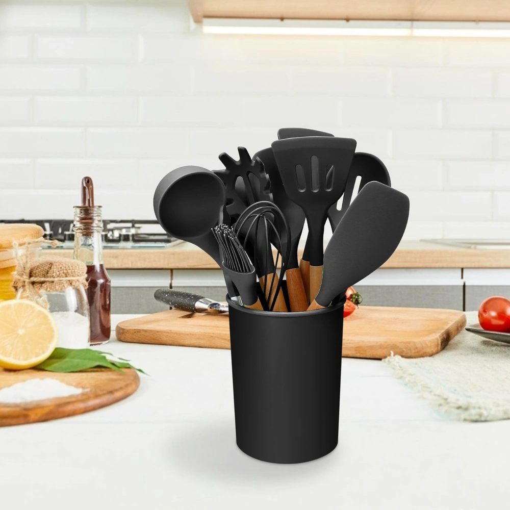 Black kitchen utensils in a holder on a modern kitchen countertop