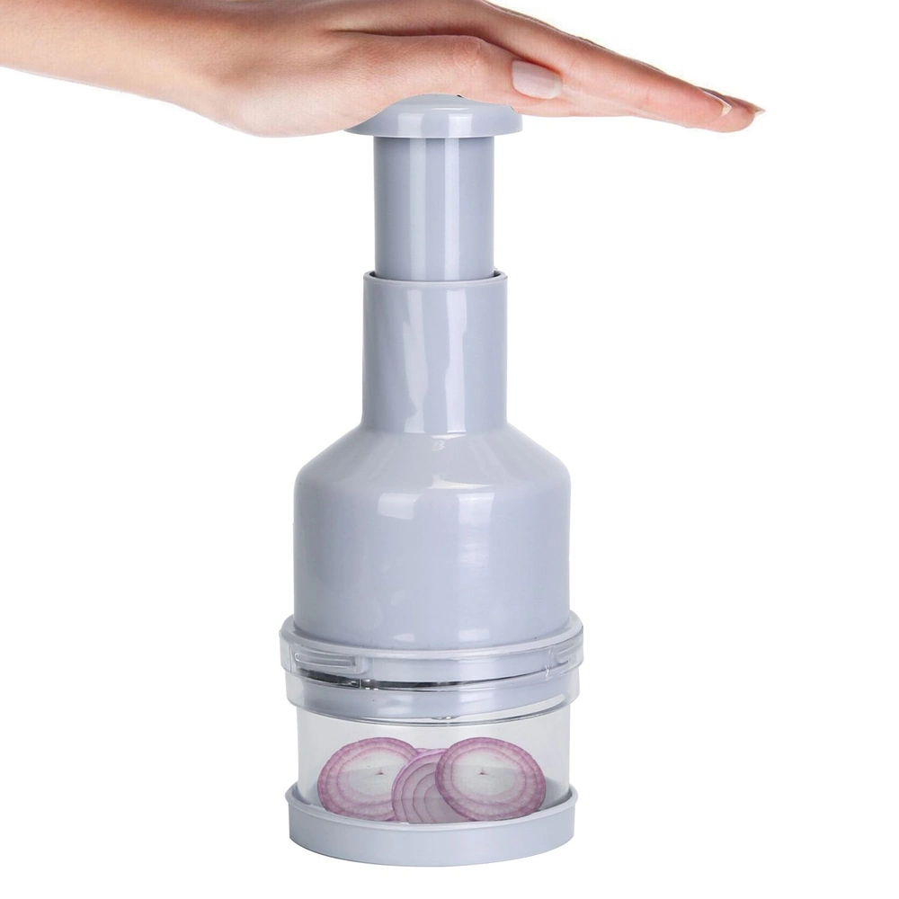 Hand using a grey manual onion chopper slicing onions
