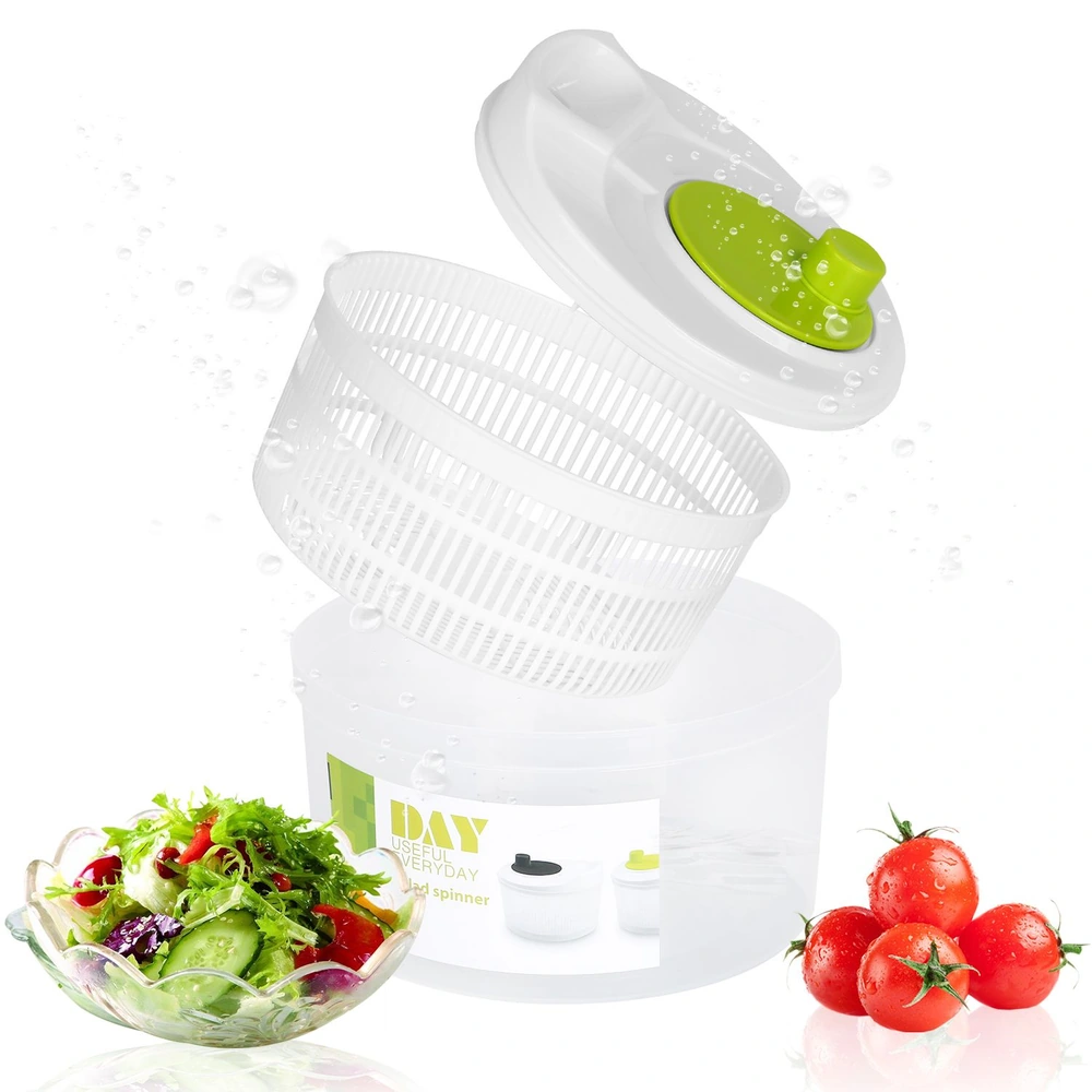 Salad spinner with flying basket and lid, next to fresh salad and tomatoes