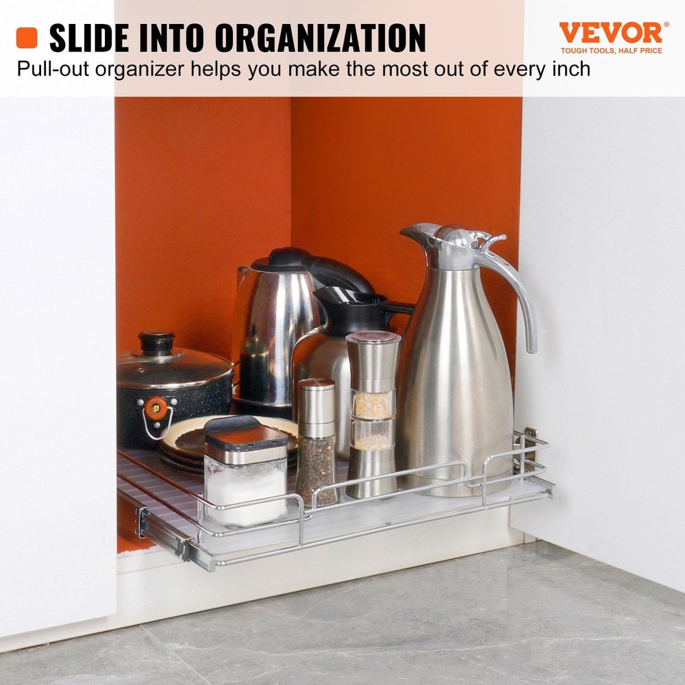 Pull-out organizer under counter storing various kitchen items including kettles, pots, spices, and a sugar container.
