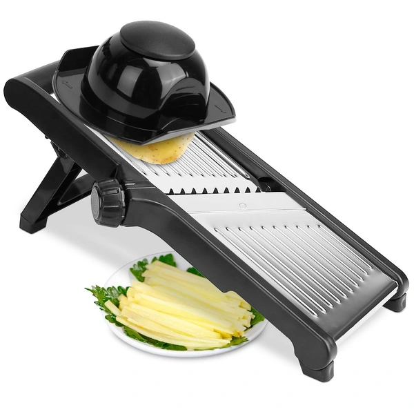 Black mandoline slicer cutting potato into french fry sticks