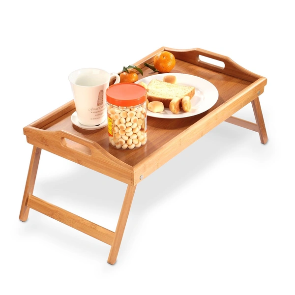 Breakfast tray with a cup of coffee, cookies, bread, and fresh oranges.