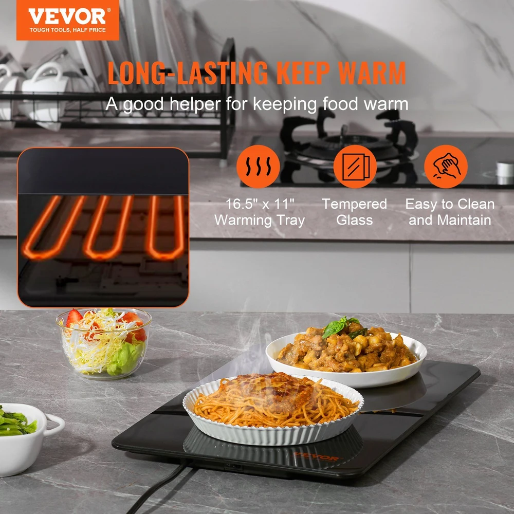 Vevor 16.5"x11" tempered glass warming tray keeping food warm in kitchen with dishes of spaghetti, salad, and meat.
