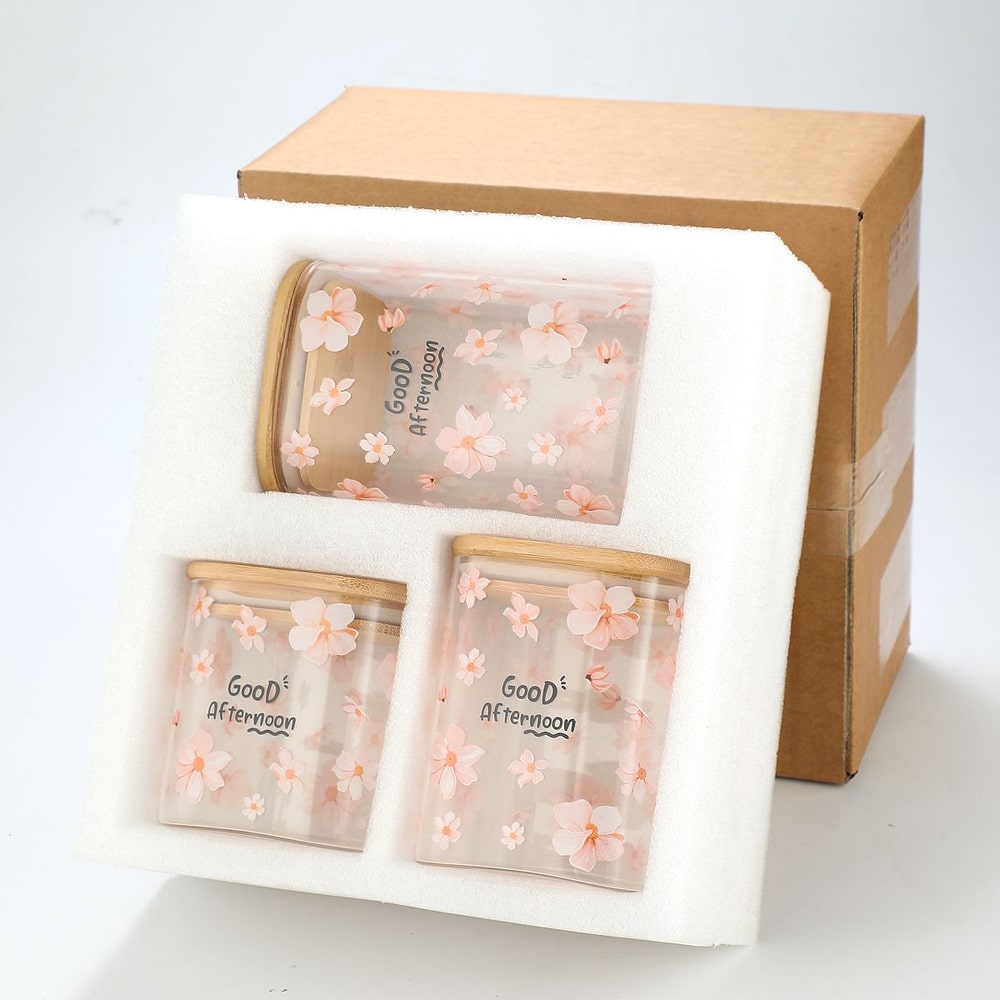 Packaging box with three floral transparent jars with 'Good Afternoon' text