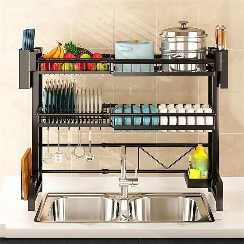 Over-the-sink kitchen rack with dishes, utensils, fruit, and cookware.