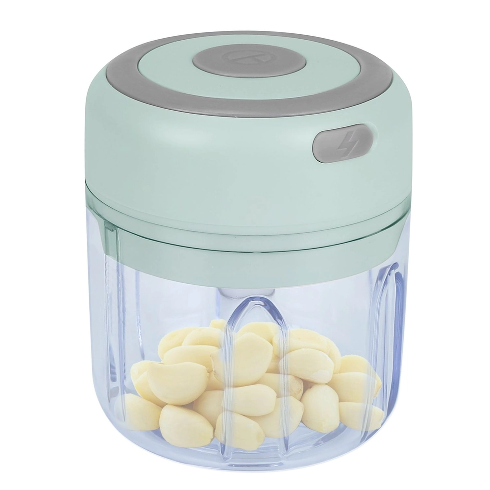 Electric mini garlic chopper with peeled garlic cloves inside.