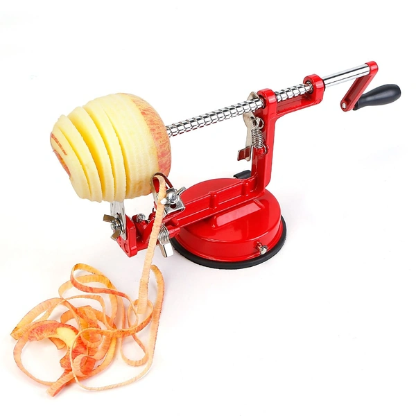 Red apple peeler corer slicer with peeled and sliced apple and apple peels.