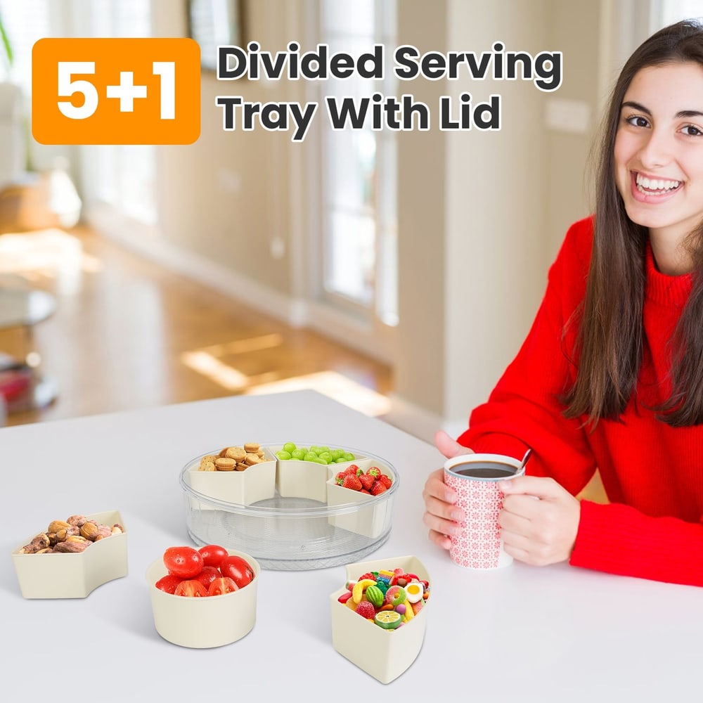 Person in red sweater with coffee sitting beside divided serving tray with lid containing various snacks.